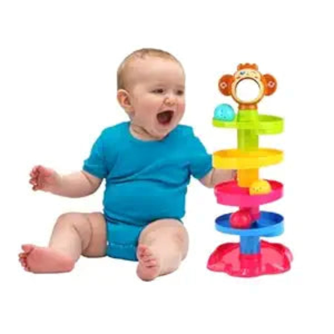 Baby sitting next to a colorful toy with a white background