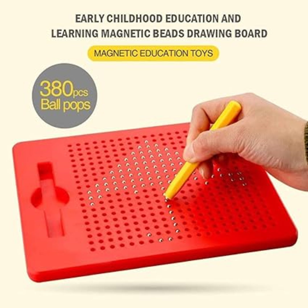 Red magnetic beads drawing board with a hand using a yellow tool, on a beige background.