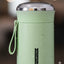 Green vacuum flask with a blurred background