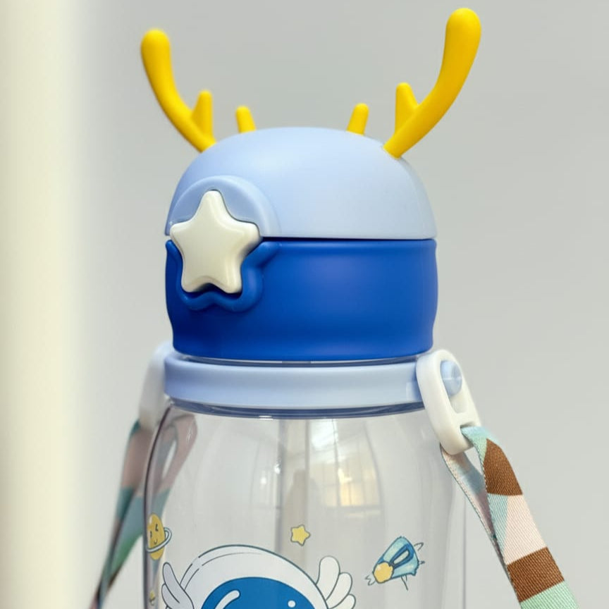 Children's tumbler with cartoon design and blue lid on a light gray background