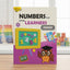 Book titled 'Numbers for Little Learners' on a table with educational items in the background