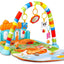 Plastic piano baby gym with colorful keys, hanging toys, and soft mat for sensory and motor skill development