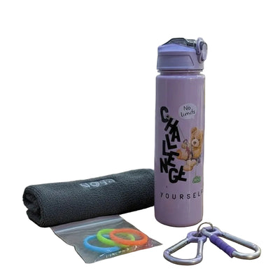 Pink water bottle with motivational text, gray towel, colorful rubber bands, and carabiner on a wooden surface.
