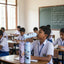 Children in a classroom with water bottles on their desks