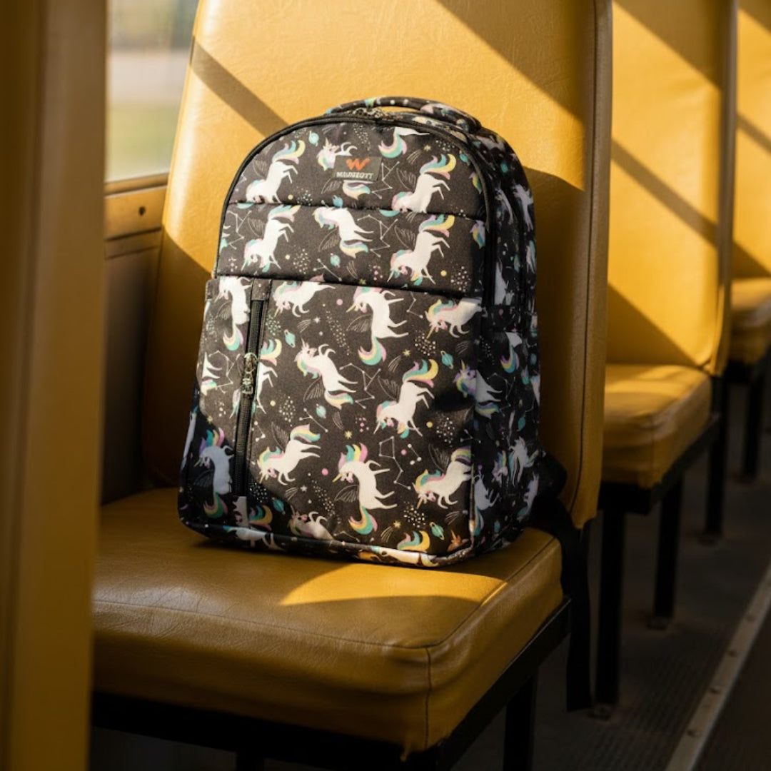 Backpack with unicorn pattern on a yellow bus seat
