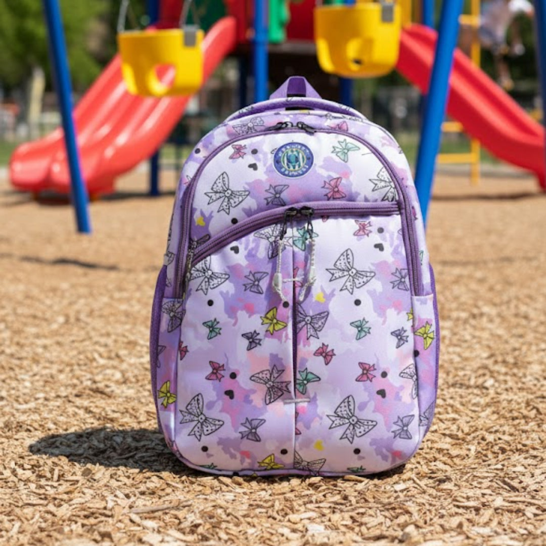 Purple backpack with butterfly design on a playground
