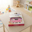 Children's toy computer on a table with educational toys in the background