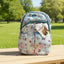 Floral-patterned backpack on a wooden bench with a park background