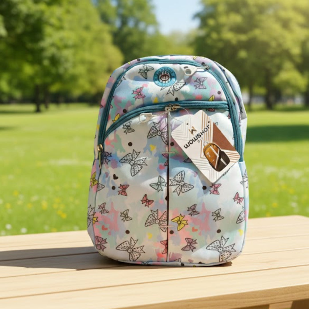 Floral-patterned backpack on a wooden bench with a park background