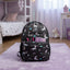 Black backpack with animal patterns on a purple rug in a bedroom