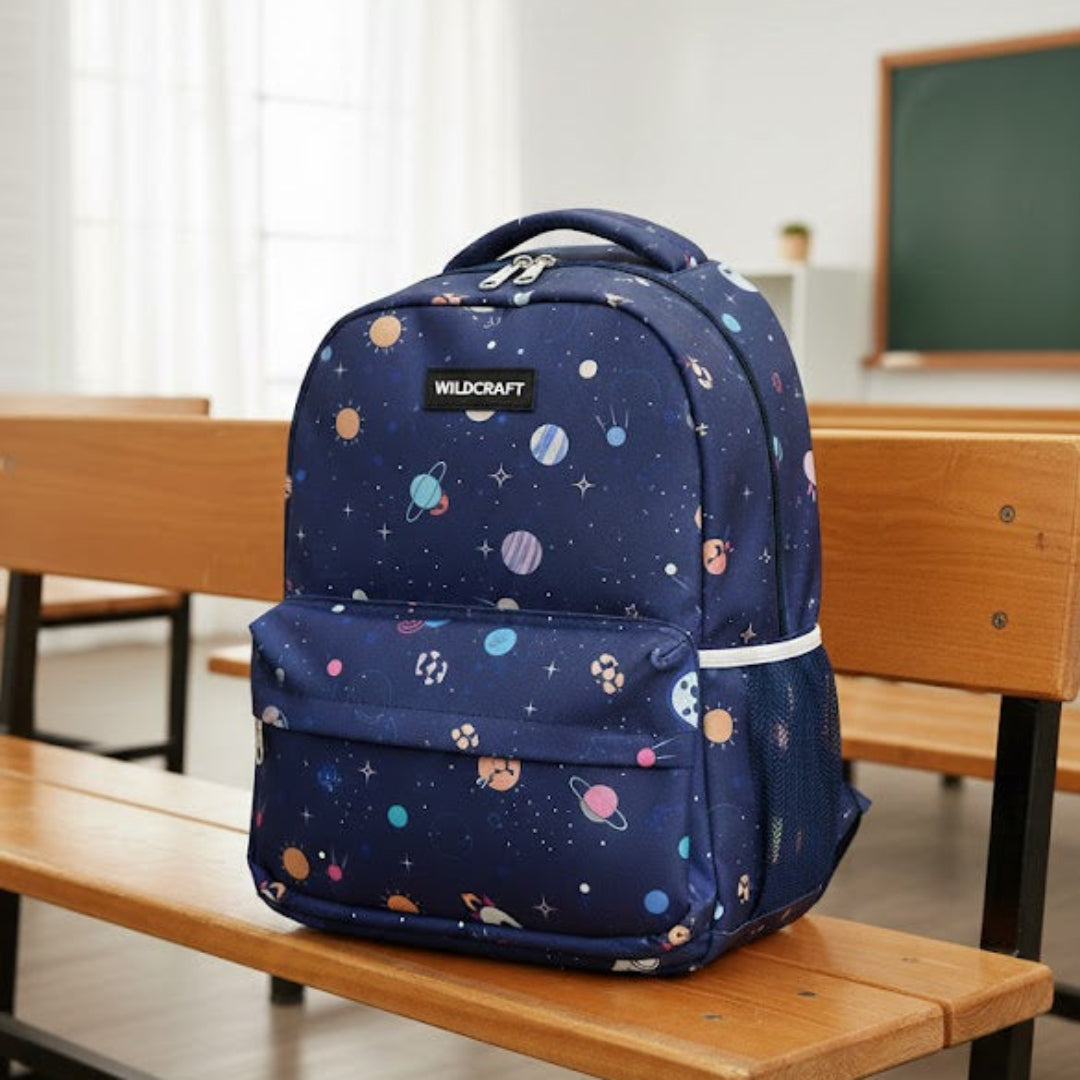 Navy blue backpack with colorful patterns on a wooden bench in a classroom setting